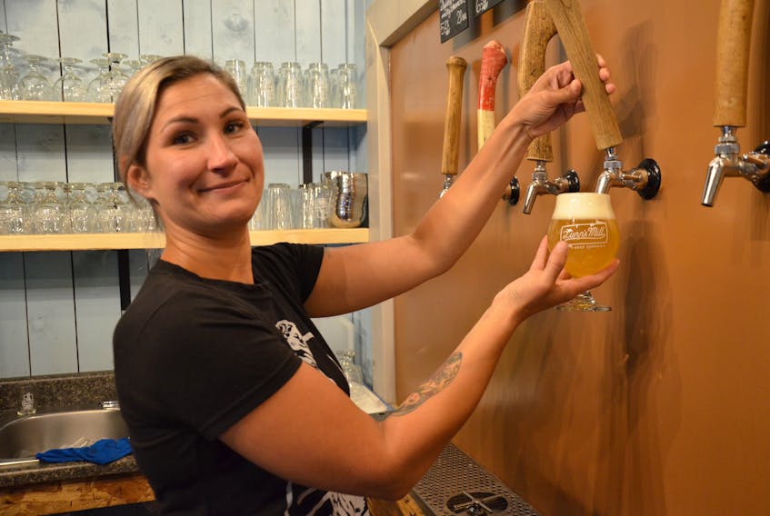 Heather Luby, taproom manager at Lunn’s Mill Beer Company in Lawrencetown, draws a Charming Molly for a customer. She says there really isn’t any defined demographic for craft beer drinkers – it appeals to all ages and genders.