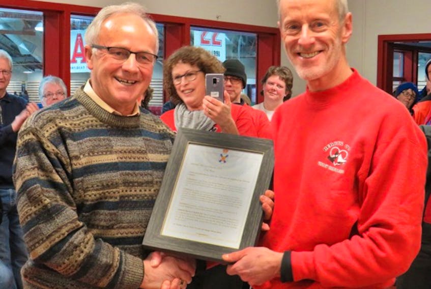 Kings West MLA Leo Glavine, left, presents Dr. Howard Wightman with the resolution he introduced in the legislature recently to recognize the Kentville-based cardiologist.