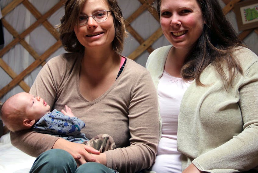 Vanessa Huntley and Gina Martin with Hewy, Gina’s youngest son. Huntley and Martin, of PinkMoon Doula and Wellness, both love babies but they want expectant mothers to feel just as special.