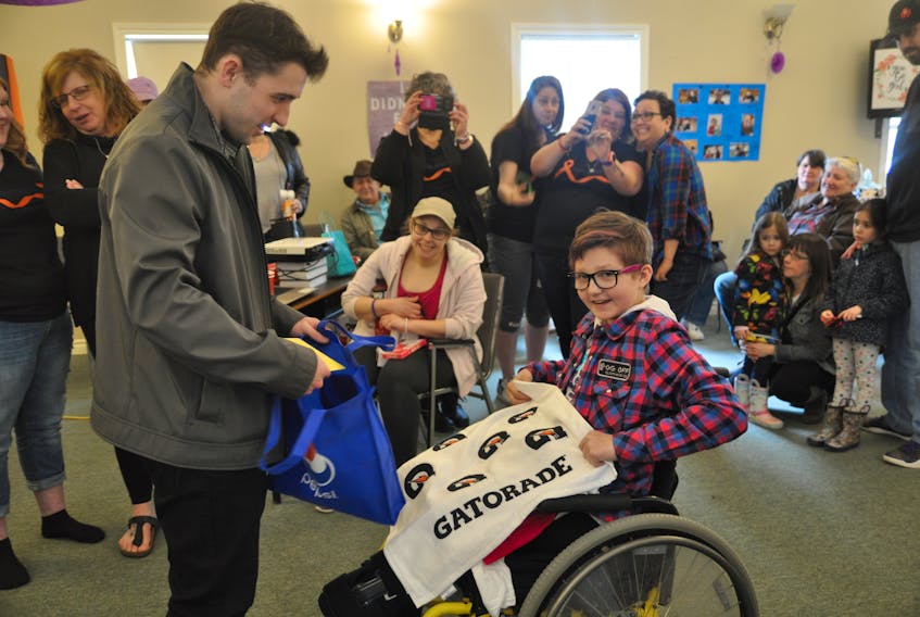 Acadia University hockey player Kyle Farrell surprised his biggest fan, Karissa Bezanson, at a surprise celebration of her now being cancer-free. Among the items he brought with him for her were Gatorade hockey towels and a water bottle.