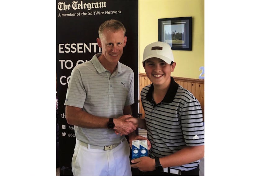 Karsen Best, the juvenile boys winner at Thursday’s Tely Tour stop in Deer Lake, is congratulated by Blomidon golf pro Wayne Allen, the Tour’s west coast co-ordinator. — Submitted