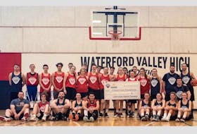 Alumni players and tournament all-stars pose together at the Waterford Valley High School gym with a cheque for the Cancer Care Foundation at the conclusion of the sixth annual Keith Keating Memorial basketball tourney. Jacob Manning photo