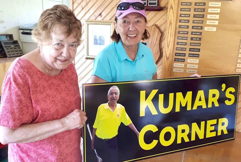 Valerie Alderson, right, surprised Kumar Uberoi’s wife of 54 years, Laura, with the unveiling of a sign in his memory during the 2019 Gary Tabor Open at the Springhill Centennial Golf Club. The sign is installed on the No. 3 hole, the water-hole near the road.