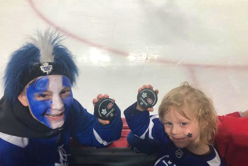 Ten-year-old Luke, left, and five-year-old Jake Parrill score pucks at a game in Montreal on Feb. 9. Their team, the Toronto Maple Leafs, were playing the Habs. CONTRIBUTED