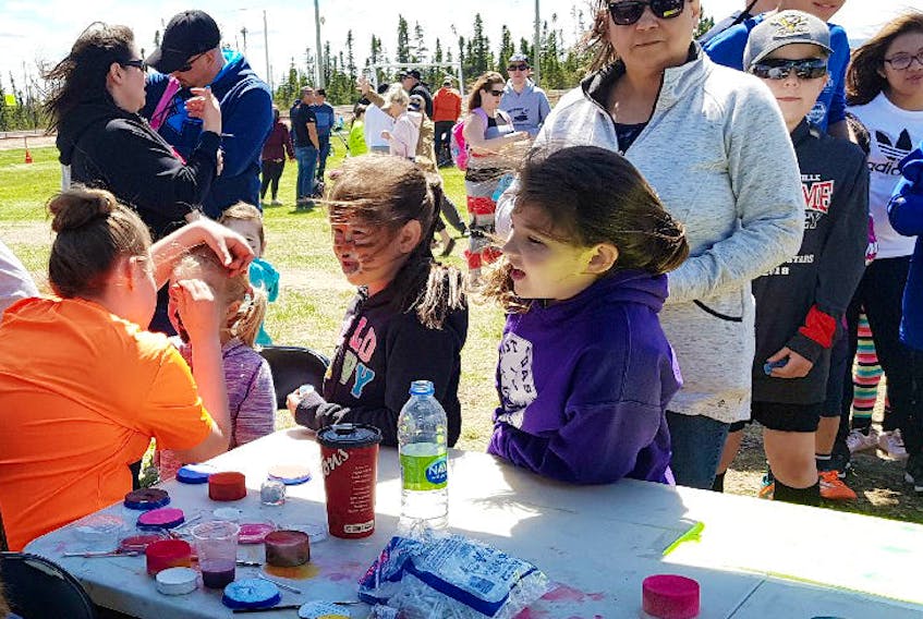 Face painting was fun for young and old alike.