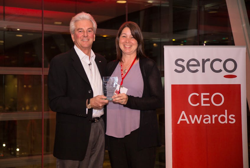 Natasha McLean accepts a leadership award from former Serco North America CEO Dan Allan in January 2017.