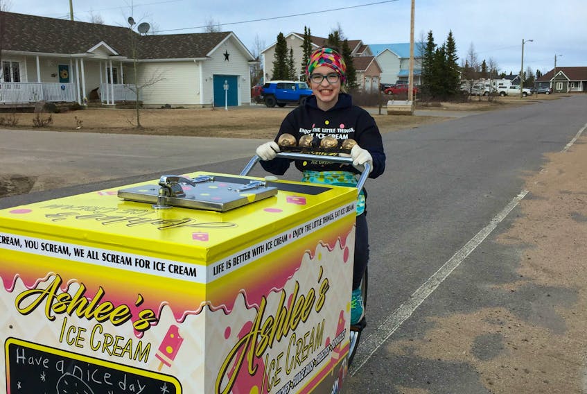 Eleven-year-old Ashlee Adams with her ice cream bicycle and ice cream freezer/cart.