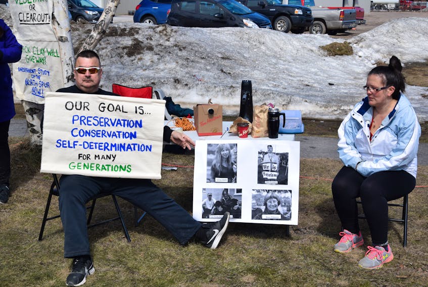 Photos of the 15 people attempting to enter the House of Commons on May 7 were at the Happy Valley-Goose Bay rally. The 15 in Ottawa were carrying photos of people in Labrador affected by the project.