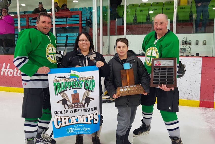 Presentation of the Trapper Cup. From left, Road Beals, Marlene Wheeler (Max Winters Daughter), Aidan Wheeler (Max Winters Grandson), Ernie McLean.