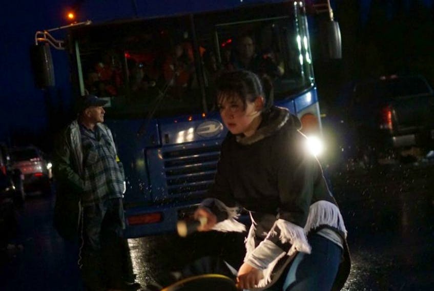 Thirteen-year-old Allyson Gear does a traditional drum dance, stopping a bus heading to the Muskrat Falls construction site. Ossie Michelin took this photo during the demonstrations in October 2016.