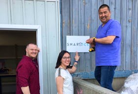 From left, Todd Perry, youth support with SmartICE; Shawna Dicker, logistics coordinator; and Rex Holwell, Northern production lead, gather outside the new facility in Nain. COURTESY OF SMARTICE INC.