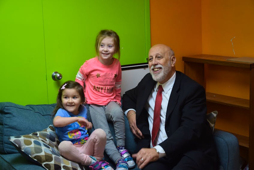 Education and Early Childhood Development Minister Al Hawkins (right) with Kaylie Webber (left) and Etta O’Brien, two of the participants in the Pumpkin House daycare.