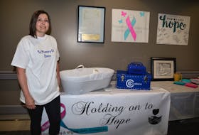 Beth Loder displays a cuddle cot Holding on to Hope donated to the local hospital. The $3,488 cot has a cooling system and is designed to give grieving parents more time to bond with their baby after a stillbirth or in the case of a child who dies shortly after birth.