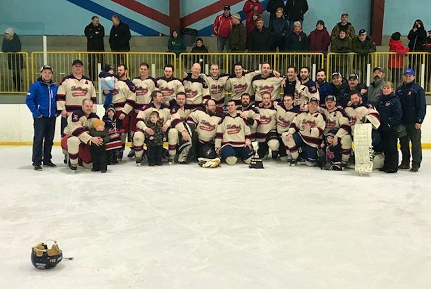 The Twillingate-New World Island Combines pose with their championship trophy.