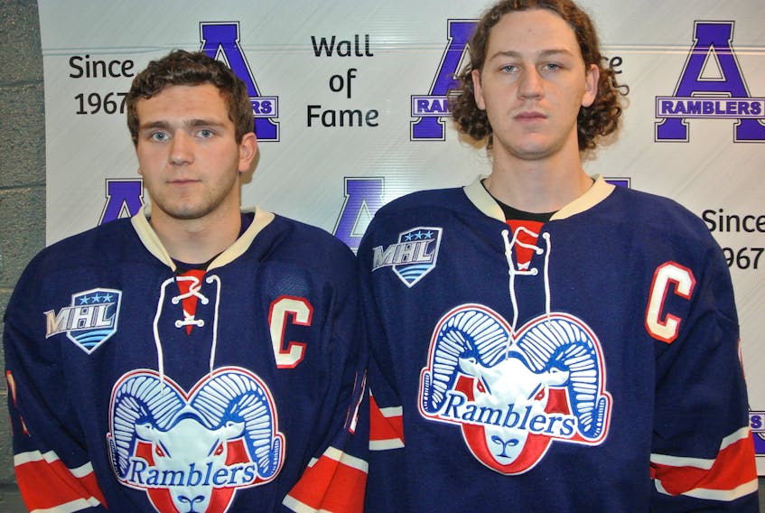 Will Lafford (left) and Dawson Grenier show off the retro jerseys the Amherst CIBC Wood Gundy Ramblers will use to open the 2019 Fred Page Cup on Wednesday against the Ottawa Junior Senators. The jerseys feature the logo the club used when it won the Maritime championship in 1990 and hosted the then Centennial Cup in 1993.