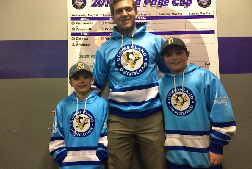 Amherst CIBC Wood Gundy Ramblers forward Will Lafford is shown with Cumberland Novice Penguins Avery Terris (left) and Camden Remington. Lafford has been helping coaching the Atlantic Hockey Group spring hockey team. The players recently thanked him by presenting him with a hoodie.