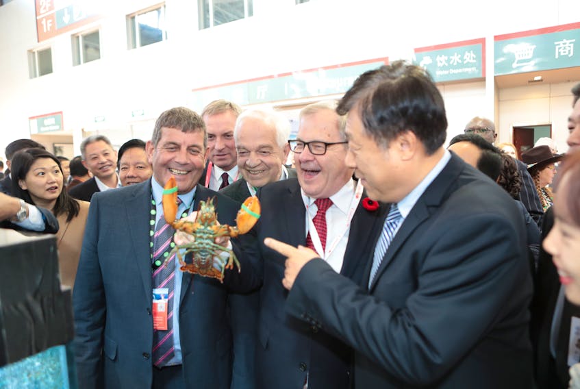 Federal Agriculture Minister and Cardigan MP Lawrence MacAulay, centre, is in Qingdao, China, at the SeaFare Expo, where he is promoting Atlantic Canadian lobsters at the Clearwater booth, which is part of the Canada Pavilion. Also attending are the vice-minister of agriculture in China, Yu Kangzhen, right. Looking over MacAulay’s shoulder is Canada's Ambassador to China, John McCallum.