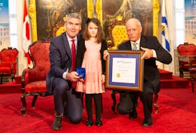 Eight-year-old Sophia LeBlanc, a Grade 2 student at West Highlands Elementary in Amherst, is presented a Nova Scotia Medal of Bravery by Premier Stephen McNeil and Lt. Gov. Arthur J. LeBlanc during a ceremony in Halifax on Dec. 4. Communications Nova Scotia photo