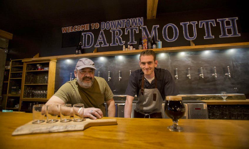 Prominent Halifax restauranteur, Leo Christakos, left, and then employee Mark Gray were photographed together in 2015 behind the bar of the newly opened Battery Park restaurant in Dartmouth. Christakos, 59, died from a heart attack on Sunday.