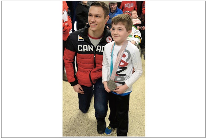 2018 PyeongChang Paralympics sledge hockey silver medallist Liam Hickey shares his medal with seven-year-old Luke Fahey following a motorcade held in Hickey’s honour Saturday.