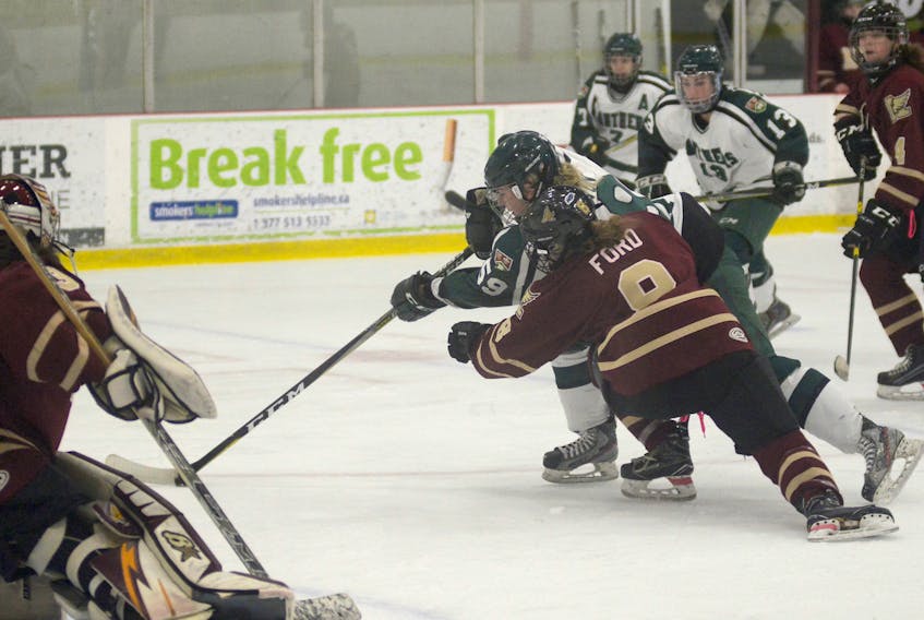 UPEI Panthers forward Lindsay Johnston fends off Mount Allison Mounties defenceman Rhiannon Ford during first period action of Saturday’s Atlantic University Sport women’s hockey game at MacLauchlan Arena.