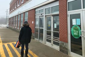 A lone customer waits outside the liquor store at Howley Estates in St. John's in this April 2020 photo.