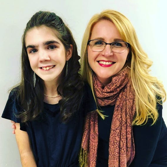 After Robin Gushue’s daughter, Olivia, was born with spastic quadriplegic cerebral palsy, epilepsy and severe gastroesophageal reflux disorder, she started a blog to share her story and connect with other parents, which has since expanded to founding Living Outside the Lines. Here, Gushue is pictured with a model at See The Ability Fashion Show. - Renena Joy photo