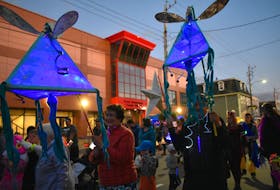 Jo Williams, left, of Tarbotvale, Victoria Co., created two beautiful blue lanterns that were paraded through downtown Sydney on Saturday.