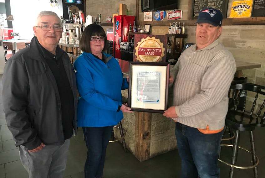 Tony Dolan, right, owner of Fat Tony's Bar and Grill accepts a plaque from Pictou Coun. Dan Currie, left, and Municipality of Pictou County Coun. Debi Wadden in recognition of its Safe Drive Home initiative.