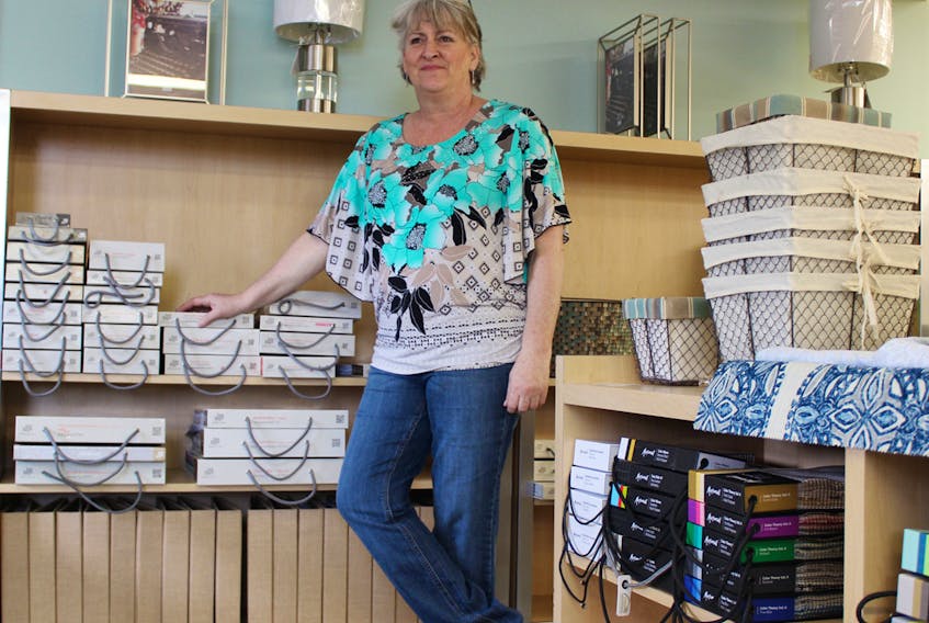 Christine Zareck looks over her designer fabric sample books at her new shop, Material Girl, on North River Road in Charlottetown. EMILY ACORN/THE GUARDIAN