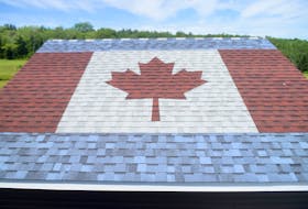 Shingle art of a Canada flag created by MMI Roofing and Carpentry.