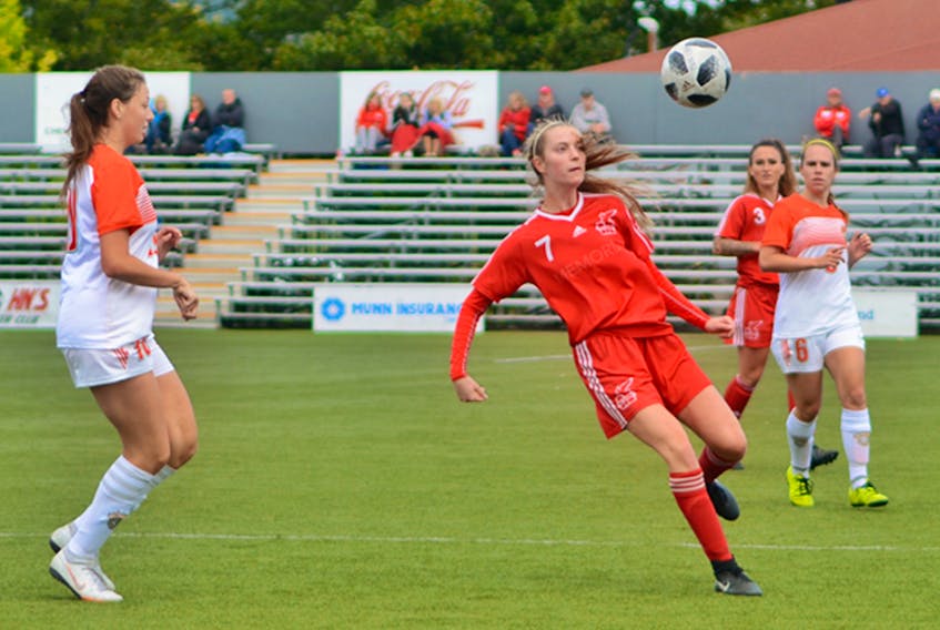 Kate Hickey (7) of the Memorial Sea-Hawks moves to control a bounding ball as Amelia Carlini (left) of the Cape Breton Capers looks on doing AUS women's soccer play at King George V Park in St. John's. — Memorial Athletics photo/Taz Uddin