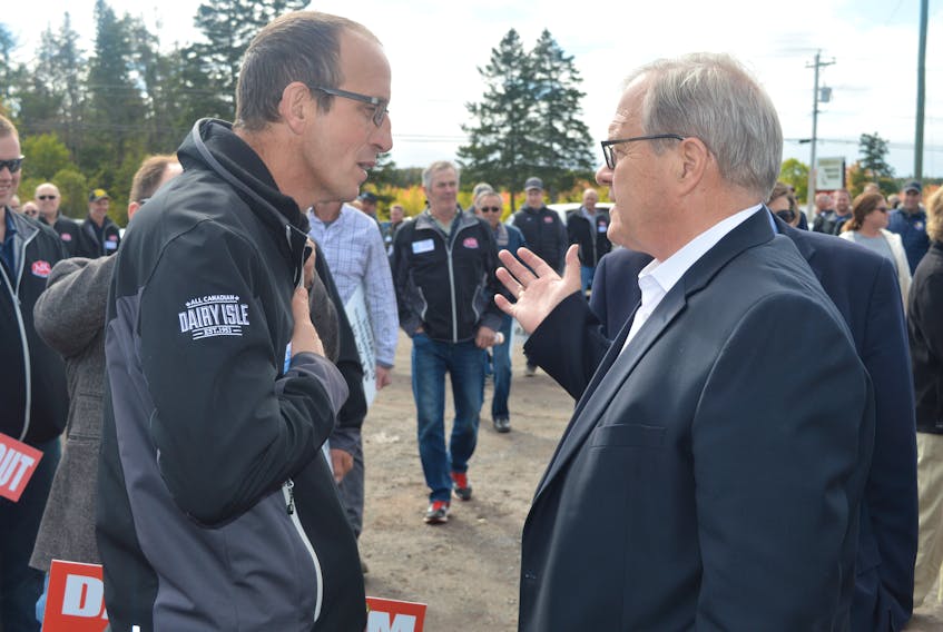 A P.E.I. dairy farmer, left, voices his displeasure with federal Agriculture Minister Lawrence MacAulay over the United States-Mexico-Canada Agreement (USMCA). More than 100 dairy farmers showed up at MacAulay’s infrastructure announcement in Pooles Corner Friday to protest the trade deal.