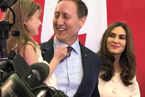 Peter MacKay grins along with wife Nazanin and one of their three children following the official announcement on Jan. 25 that he would run for the federal Conservative leadership.