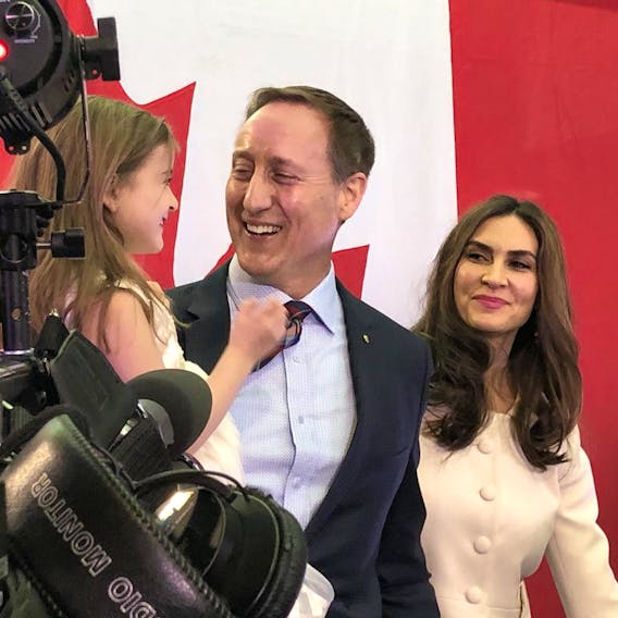 Peter MacKay grins along with wife Nazanin and one of their three children following the official announcement on Jan. 25 that he would run for the federal Conservative leadership.