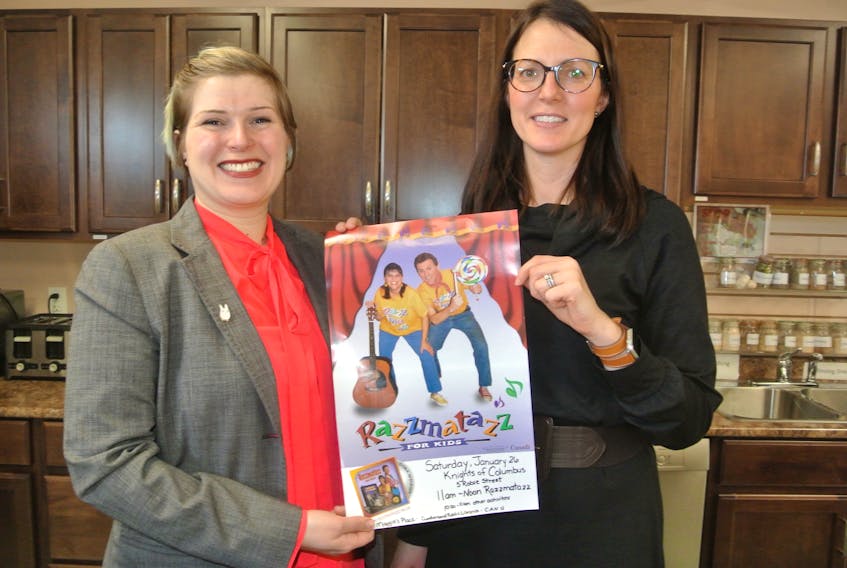 Fiona Watson (left) youth services librarian for the Cumberland Public Libraries and Sarah MacMaster, executive director of Maggie’s Place Family Resource Centre in Amherst, look over a poster for a Family Literacy Day event on Jan. 26 at the Knights of Columbus Hall on Robie Street featuring Razzmatazz. There is no cost to attend.