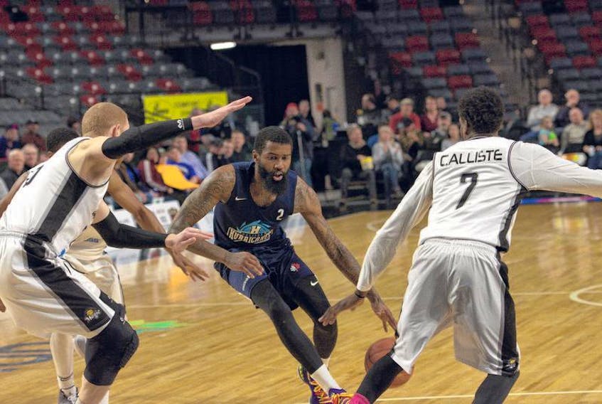 Halifax Hurricanes’ Terry Thomas tries to drive past Moncton Magic’s Jason Calliste during Game 5 of their NBL Canada semifinal series on Wednesday night in Moncton.