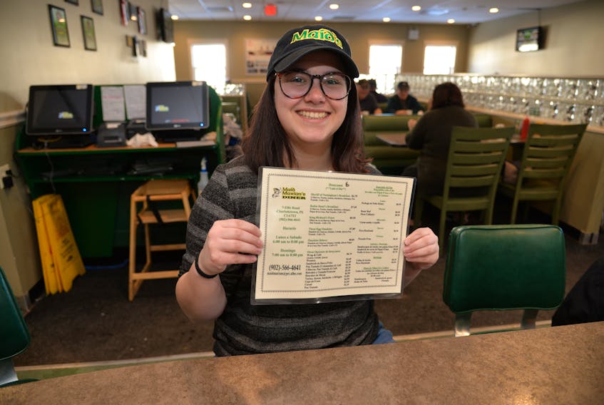 Gabrielle Richard of Maid Marian’s Diner holds one of the English-to-Spanish translated menus on Thursday.