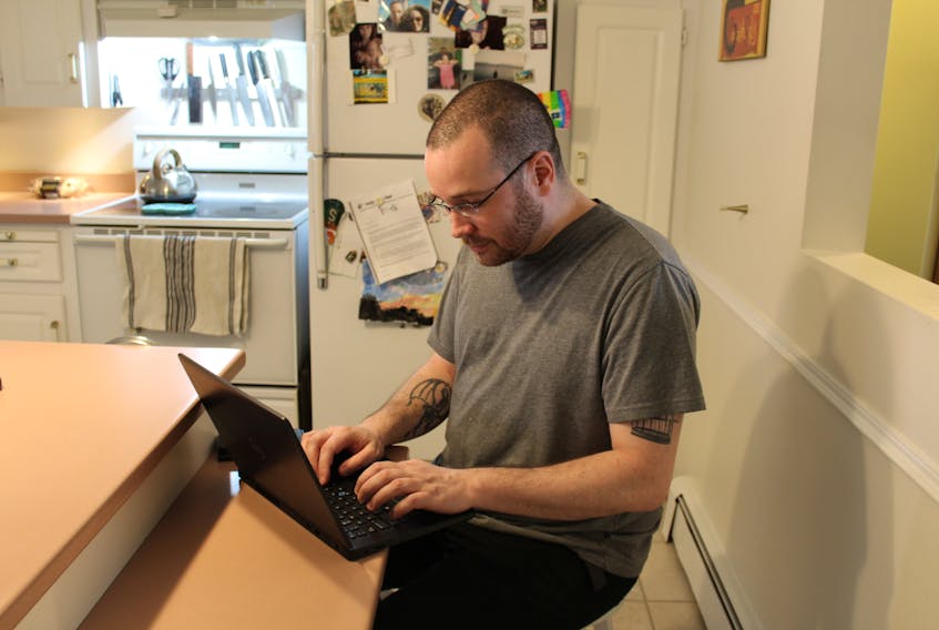 Scott Pyke at his computer. Most of his searching for his biological family was done online.  - Olivia Malley