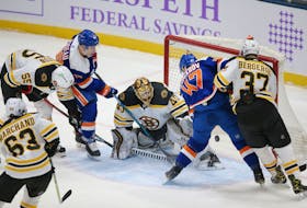 New York Islanders' winger Leo Komarov (47) scores a goal against Boston Bruins goalie Tuukka Rask (40) during the first period of an NHL game Saturday at Nassau Veterans Memorial Coliseum. - Brad Penner / USA Today Sports