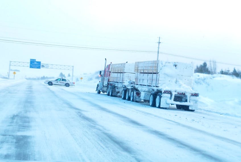 An RCMP cruiser blocks the eastbound lane of Highway 104 at the entrance to Nova Scotia during a recent highway closure caused by severe weather. Mike Johnson/Cumberland EMO photo