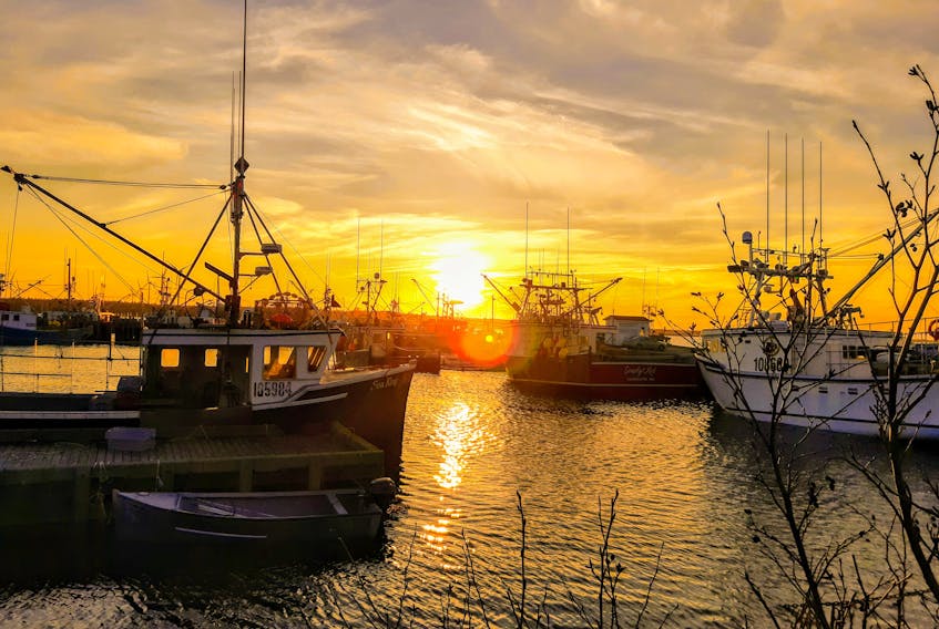 Sunsets – they symbolize the completion of a day's work and show the passage of time.  This stunning sunset photo was taken by Barbara Fowler as the deepening golden glow washed over the wharf at Lower East Pubnico, Nova Scotia.