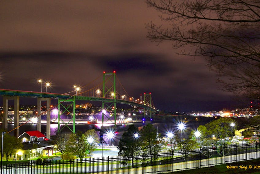 Warren Hoeg said it was a cold photo shoot, in light drizzle and with a windchill one evening last week.  There was a bonus… no fog! This is a stunning photo of the A. Murray MacKay bridge, Halifax bound, as seen from the Bedford Institute of Oceanography, Dartmouth, N.S.