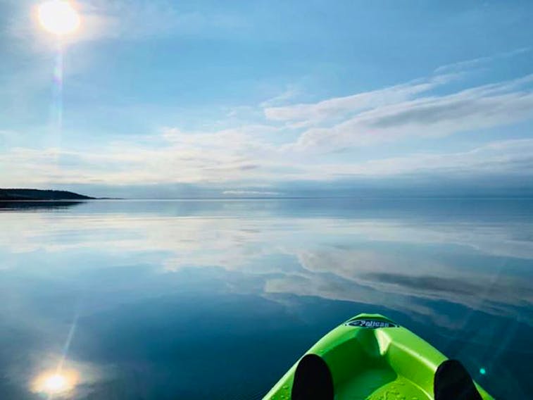 Peace, tranquillity and beauty as far as the eye can see.  Allie Feltmate chose the perfect evening for a paddle off Canso Nova Scotia. The late-day breeze subsided, allowing the perfectly calm waters to reflect streaks of midlevel clouds that dotted the horizon.