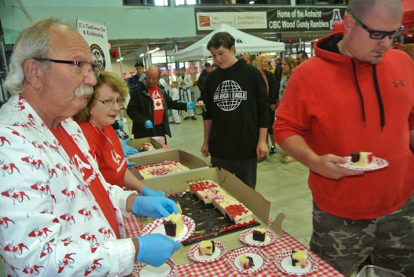 Amherst Mayor David Kogon and Deputy Mayor Sheila Christie hand out Canada Day cake on July 1 at the Amherst Stadium.