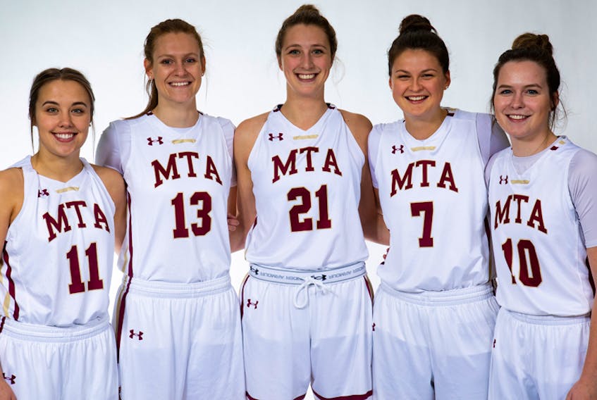Amherst’s Lauren Chitty, left, and Lauren MacEachern, right, along with four other Mounties graduates, were celebrated during their final home game with the Mounties on Feb. 23. Other graduates joining in the celebration were: (beginning second, from left) Kiersten Mangold, Lauren Wentzell, and Kathleen Morrison. Not pictured is graduate Katherine Ollerhead.