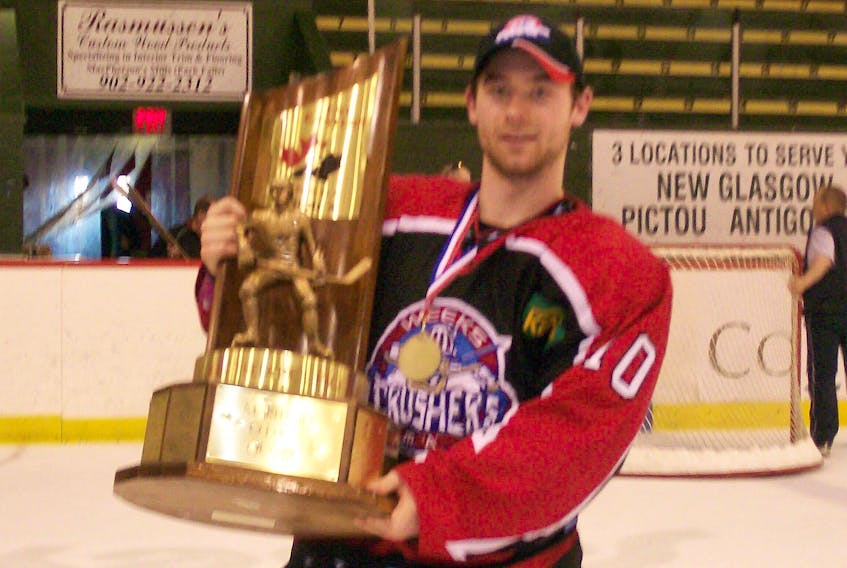 Scott McManaman of Amherst holds up the Fred Page Cup he won as a member of the Pictou County Weeks Crushers in 2008. McManaman is the only Amherst player to win a Fred Page Cup championship.