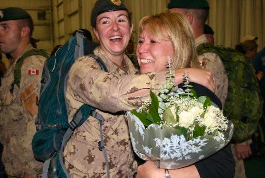 Melanie Lake gets a warm reception from her mother Nora after returning from deployment in October 2008.
