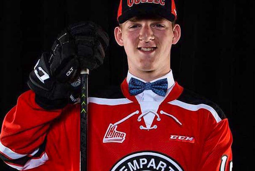 Jacob Melanson proudly wears the hat and sweater of the Quebec Remparts, the team that took him 15th overall at the 2019 QMJHL entry draft in Quebec City. - Quebec Remparts photo