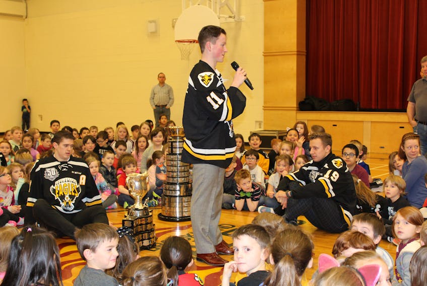 Cape Breton Screaming Eagles player Derek Gentille, centre, talks with students at Brookland Elementary on Friday. He was joined by teammates Mitchell Balmas, left, and Shaun Miller, to his right. The trio also brought with them the Memorial Cup that’s awarded to the Canadian Hockey League champion each year and the President’s Cup that goes to the Quebec Major Junior Hockey League champion.